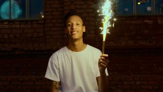 Man in White Crew Neck T-shirt Holding Fire